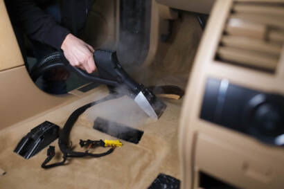 A variety of car detailing tools and products arranged on a table, ready for use.