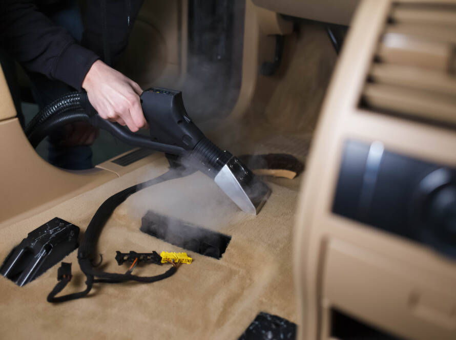 A variety of car detailing tools and products arranged on a table, ready for use.