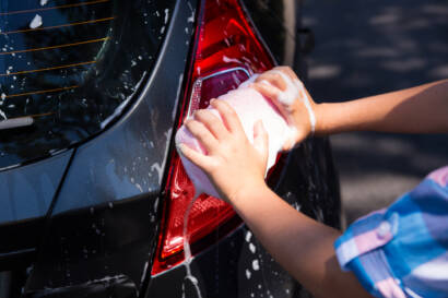 Close-up of a car panel before and after paint correction, showcasing the removal of swirl marks and scratches.