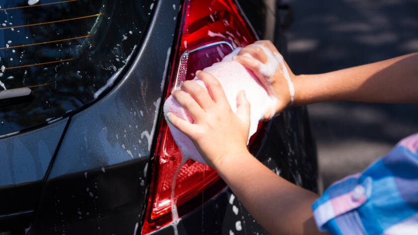 Close-up of a car panel before and after paint correction, showcasing the removal of swirl marks and scratches.