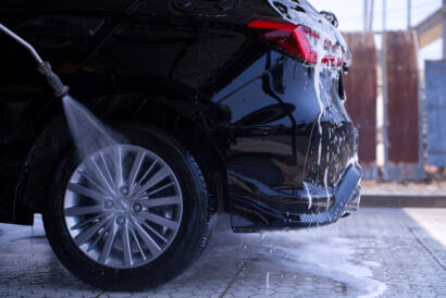 A luxury car being meticulously hand-washed by an 85AutoSpa detailer in Sandy Springs.