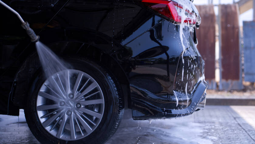 A luxury car being meticulously hand-washed by an 85AutoSpa detailer in Sandy Springs.