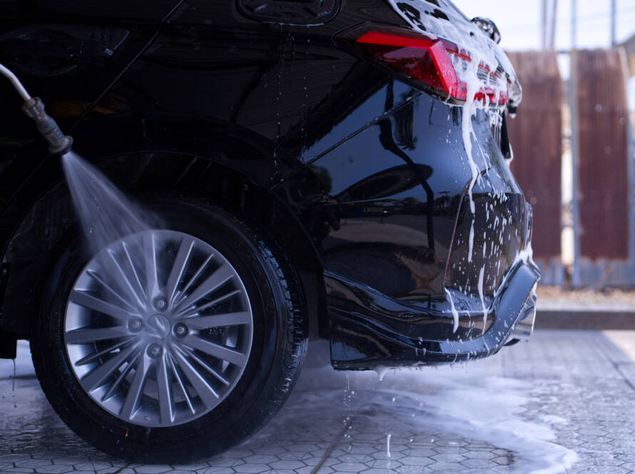 A luxury car being meticulously hand-washed by an 85AutoSpa detailer in Sandy Springs.