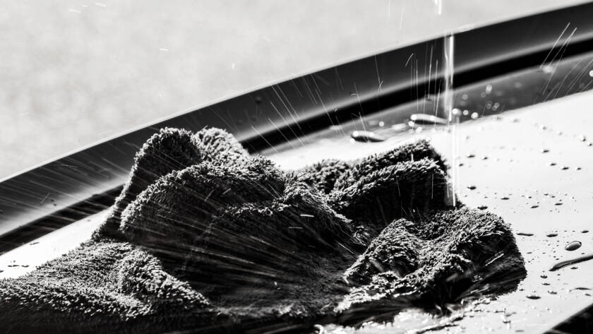 A close-up photo of a car's hood with invisible PPF applied, showcasing its protective properties.