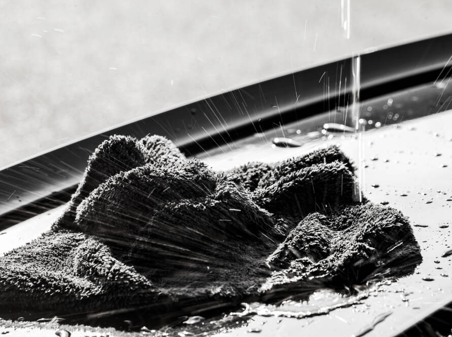 A close-up photo of a car's hood with invisible PPF applied, showcasing its protective properties.