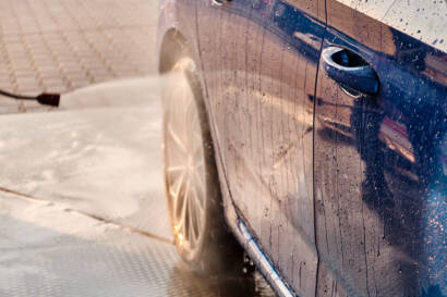 A car with a gleaming, mirror-like finish after waxing.