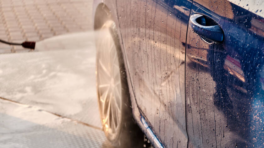 A car with a gleaming, mirror-like finish after waxing.