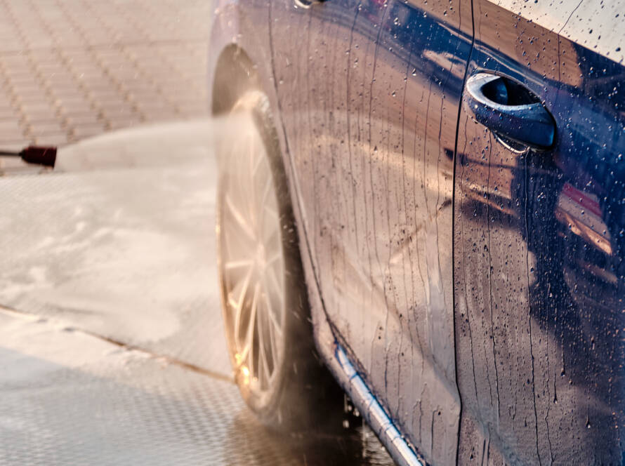 A car with a gleaming, mirror-like finish after waxing.