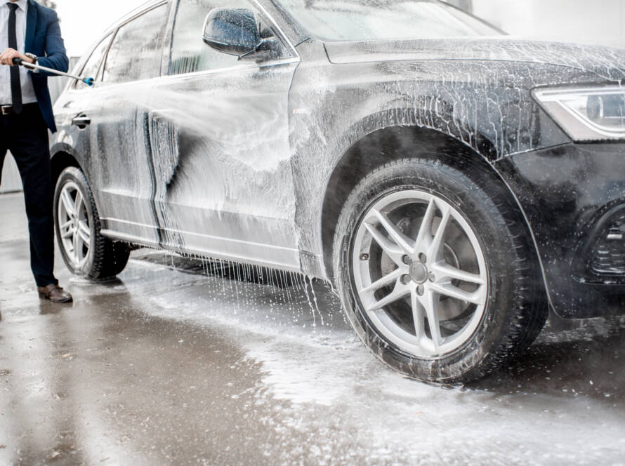 A close-up photo of a soft microfiber mitt being used to wash a car at 85AutoSpa.