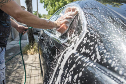 A close-up photo of a water beading on a ceramic coated car hood.