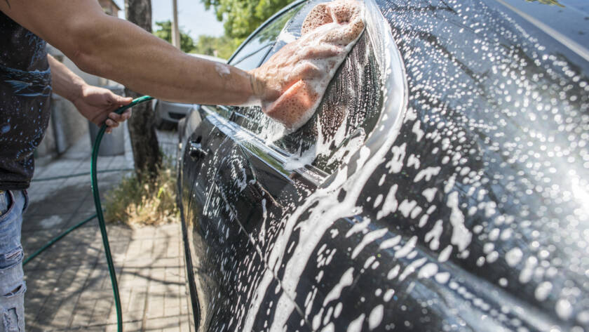 A close-up photo of a water beading on a ceramic coated car hood.