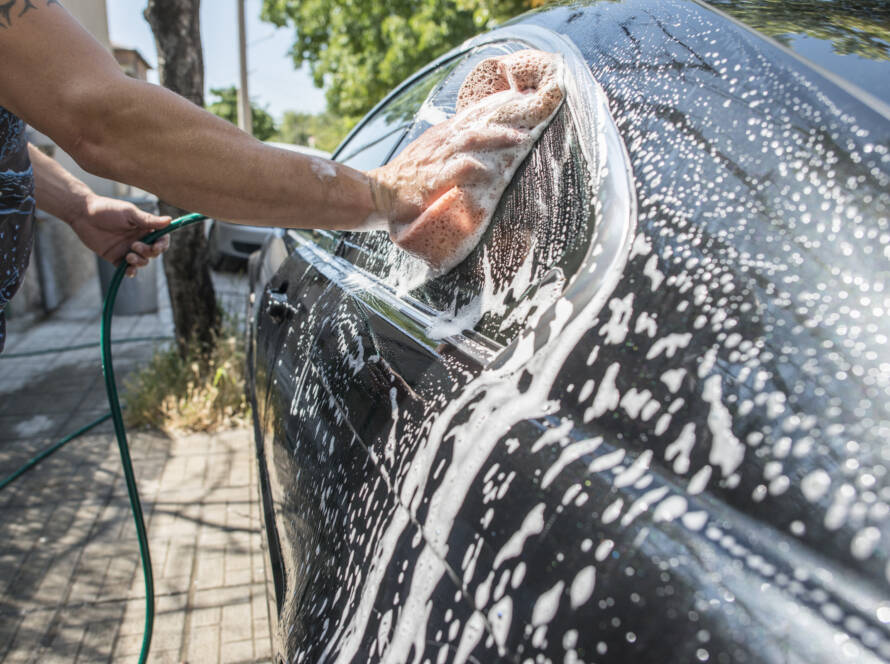 A close-up photo of a water beading on a ceramic coated car hood.