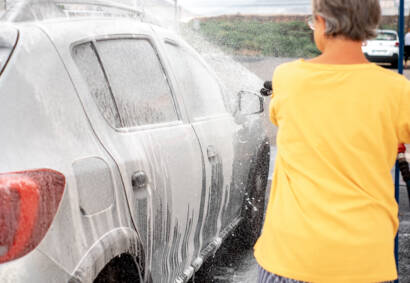 Clean leather car seats, spotless dashboard, and gleaming wood trim after professional interior detailing."