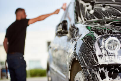 A luxury car being meticulously detailed by 85AutoSpa technicians.