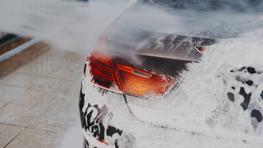 A close-up of a car's front bumper with transparent PPF applied, demonstrating its invisible protection.