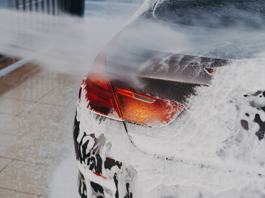 A close-up of a car's front bumper with transparent PPF applied, demonstrating its invisible protection.