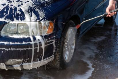 A close-up photo of a gleaming car exterior after detailing, emphasizing the "best auto detailing near me" experience.