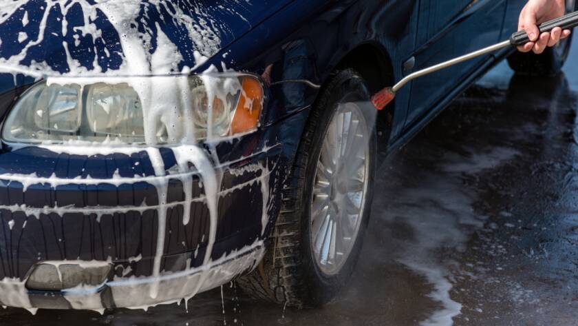 A close-up photo of a gleaming car exterior after detailing, emphasizing the "best auto detailing near me" experience.