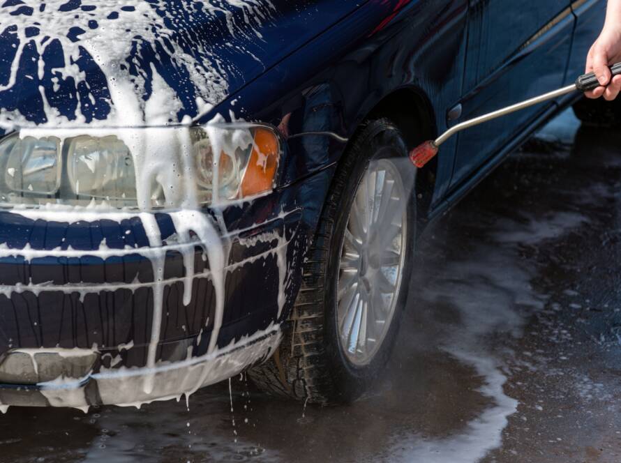 A close-up photo of a gleaming car exterior after detailing, emphasizing the "best auto detailing near me" experience.