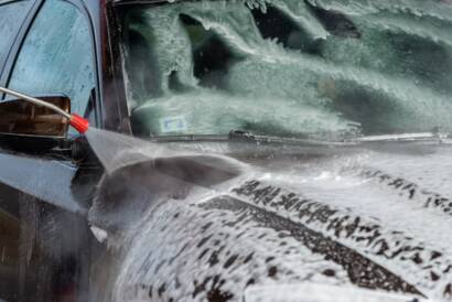 Water beading on a ceramic-coated car hood, showcasing the protective properties of the "best auto detailing near me."