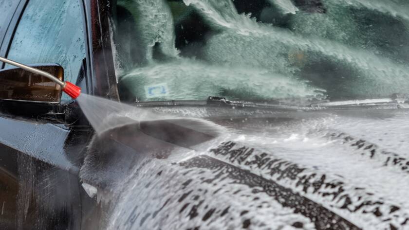 Water beading on a ceramic-coated car hood, showcasing the protective properties of the "best auto detailing near me."