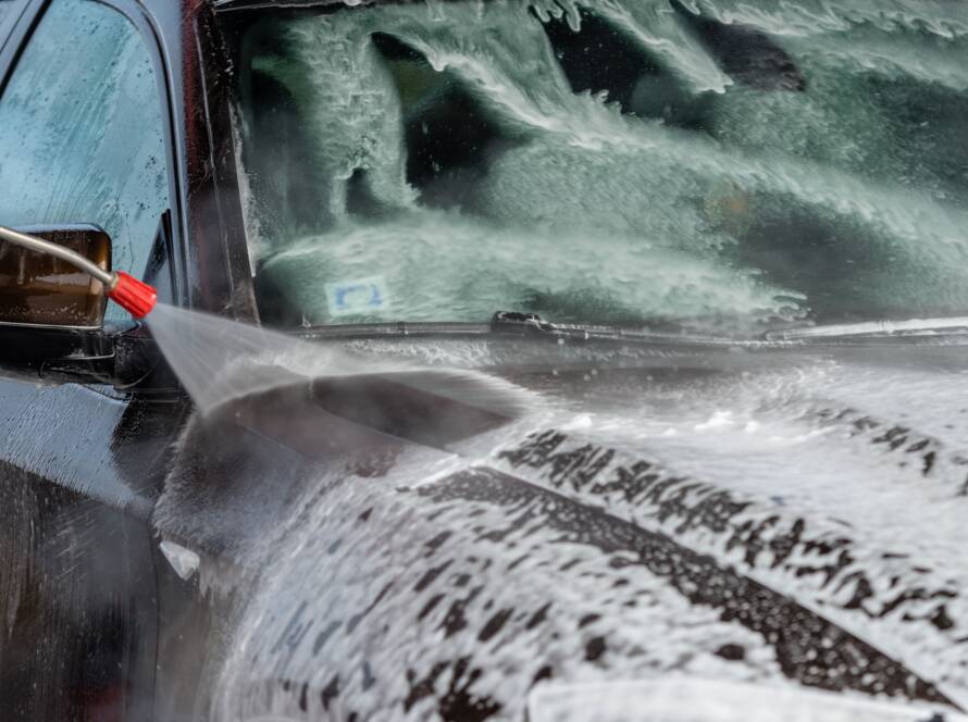 Water beading on a ceramic-coated car hood, showcasing the protective properties of the "best auto detailing near me."